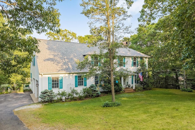 43 Owl Pond Rd, Brewster, MA 02631 - colonial home featuring asphalt driveway, a front yard, an attached garage, and a shingled roof