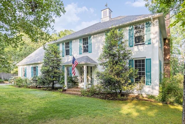 43 Owl Pond Rd, Brewster, MA 02631 - colonial home with a front yard and a chimney