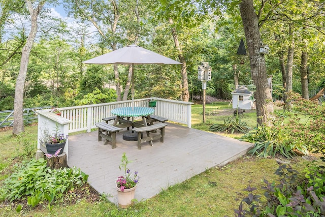 43 Owl Pond Rd, Brewster, MA 02631 - wooden terrace featuring outdoor dining area, an outbuilding, and view of wooded area