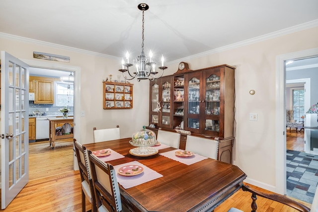 43 Owl Pond Rd, Brewster, MA 02631 - dining area with a chandelier, crown molding, light wood-type flooring, and french doors
