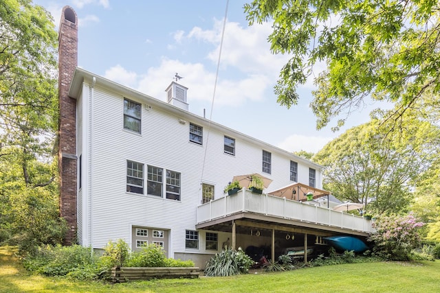 43 Owl Pond Rd, Brewster, MA 02631 - rear view of house with a chimney, a deck, and a yard