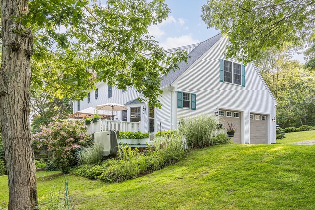 43 Owl Pond Rd, Brewster, MA 02631 - rear view of property with a wooden deck, a lawn, and a chimney