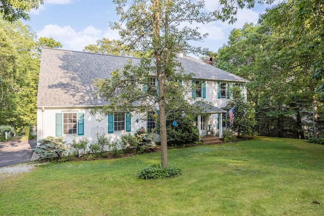 43 Owl Pond Rd, Brewster, MA 02631 - colonial-style house with a front yard, a chimney, and roof with shingles