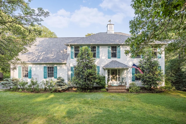 43 Owl Pond Rd, Brewster, MA 02631 - colonial inspired home featuring a chimney, a front lawn, and roof with shingles
