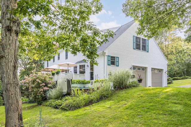 43 Owl Pond Rd, Brewster, MA 02631 - back of property with an attached garage, a shingled roof, and a yard