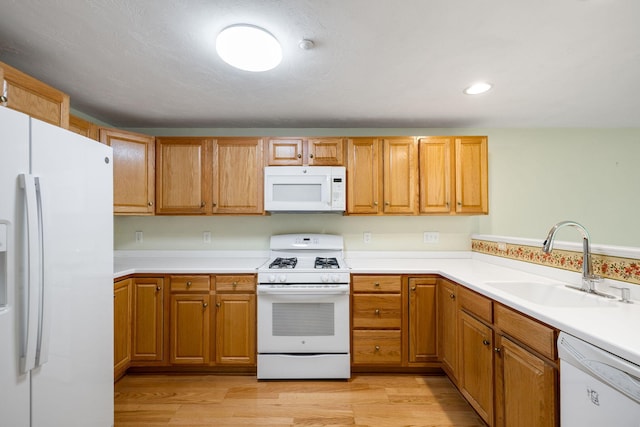 15 Pebble Beach Ave, Mashpee, MA 02649 - kitchen featuring white appliances, light wood-style flooring, light countertops, brown cabinets, and recessed lighting