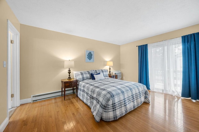 800 Bearses Way Unit 1Wd, Hyannis, MA 02601 - bedroom featuring a baseboard heating unit, hardwood / wood-style floors, and multiple windows
