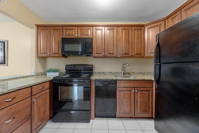 800 Bearses Way Unit 1Wd, Hyannis, MA 02601 - kitchen with black appliances, brown cabinetry, light stone counters, and light tile patterned flooring