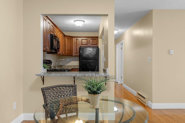 800 Bearses Way Unit 1Wd, Hyannis, MA 02601 - dining area featuring a baseboard radiator and light wood finished floors