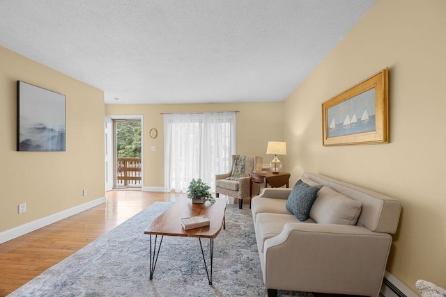 800 Bearses Way Unit 1Wd, Hyannis, MA 02601 - living area featuring wood finished floors, a baseboard radiator, and a textured ceiling