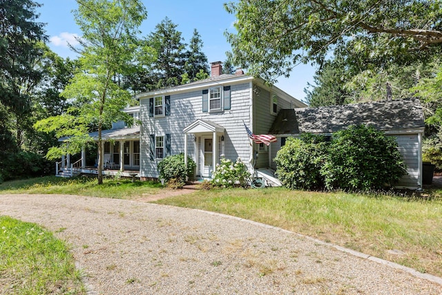 view of front of property featuring a porch and a front lawn