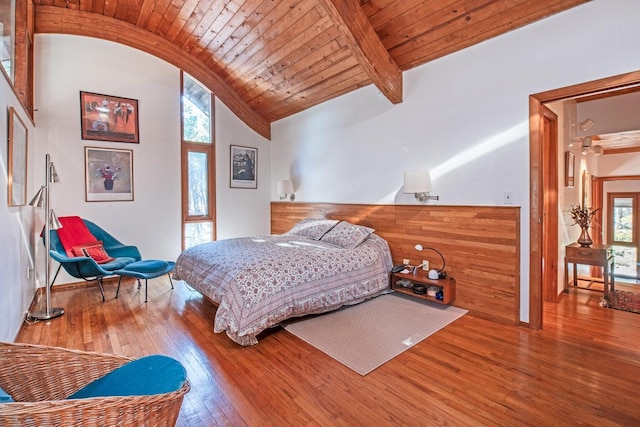 bedroom featuring vaulted ceiling with beams, hardwood / wood-style floors, and wooden ceiling