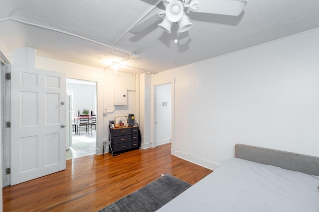 352 Bishop St, Framingham, MA 01702 - bedroom with wood finished floors, electric panel, a ceiling fan, and a textured ceiling