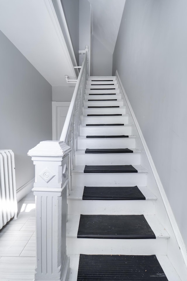 352 Bishop St, Framingham, MA 01702 - stairway featuring radiator heating unit and baseboards