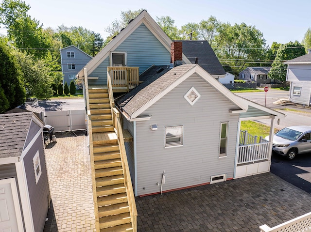 352 Bishop St, Framingham, MA 01702 - view of home's exterior with stairway, fence, a patio, and a gate