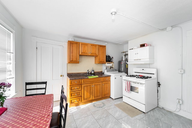 352 Bishop St, Framingham, MA 01702 - kitchen featuring gas range gas stove, washer / clothes dryer, water heater, a sink, and tasteful backsplash