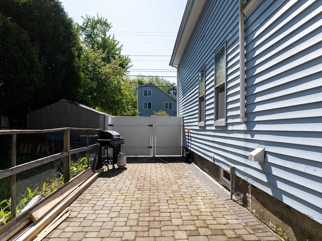 352 Bishop St, Framingham, MA 01702 - view of home's exterior with fence, a patio, a gate, and an outbuilding