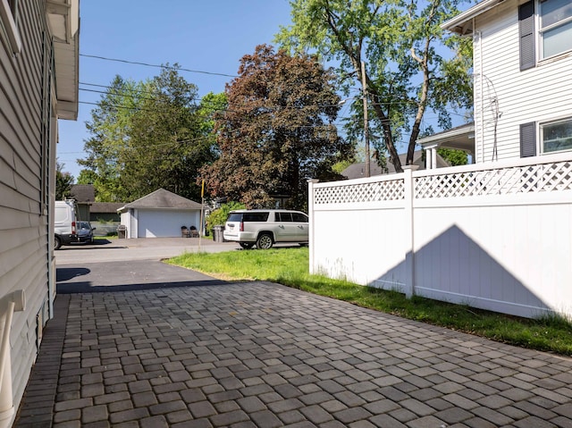 352 Bishop St, Framingham, MA 01702 - view of patio featuring a detached garage and fence