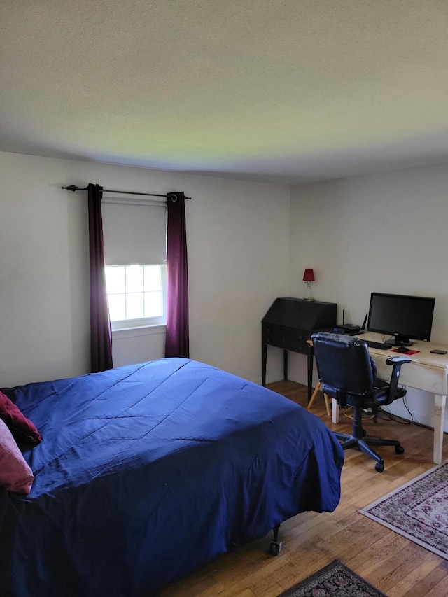 bedroom featuring wood finished floors