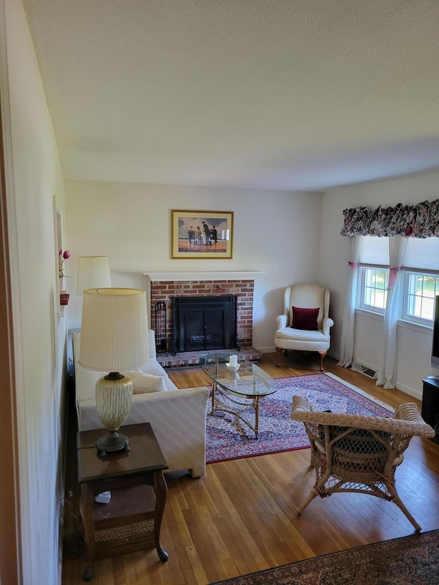 living room featuring a fireplace and wood finished floors