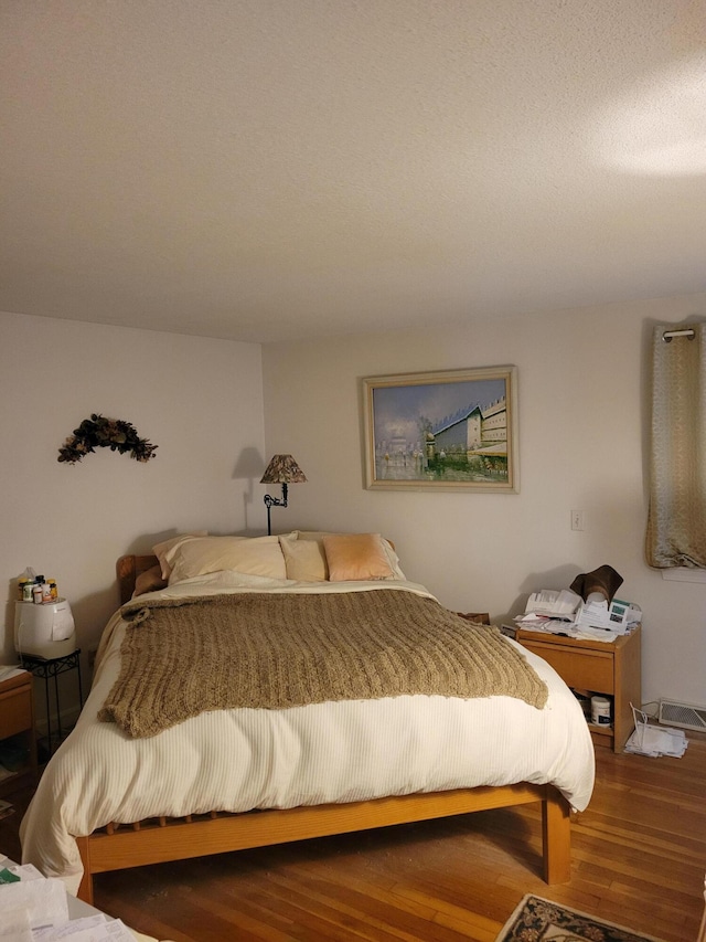 bedroom with wood finished floors