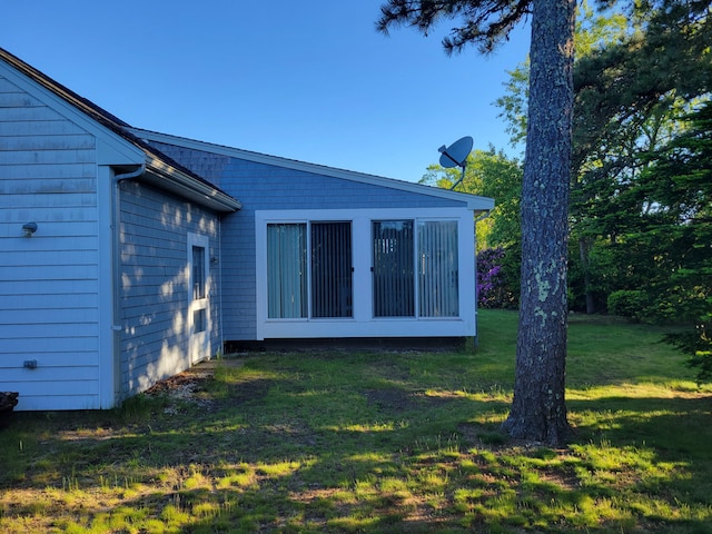 view of side of home with a lawn