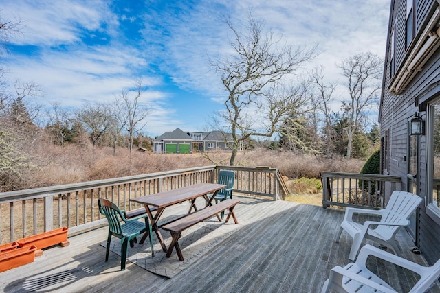 wooden terrace featuring outdoor dining area