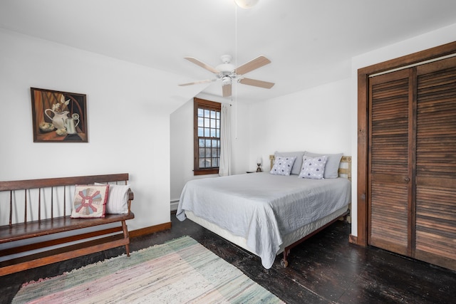 bedroom featuring a closet, a ceiling fan, baseboards, and a baseboard radiator