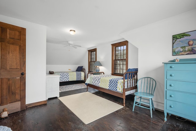 bedroom featuring lofted ceiling, wood finished floors, and baseboards