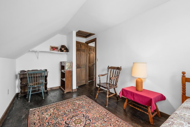 bedroom with lofted ceiling, wood finished floors, and baseboards