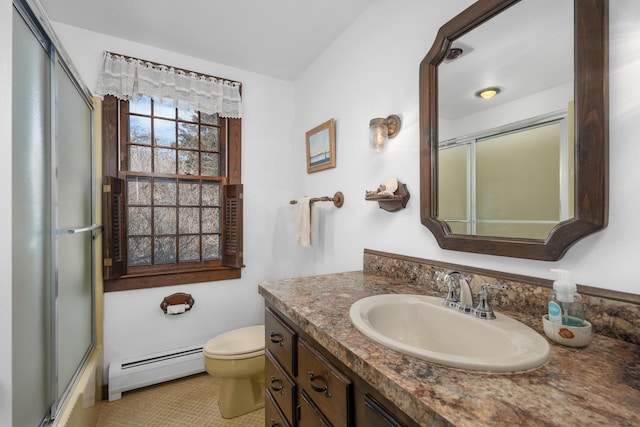 bathroom featuring vanity, toilet, combined bath / shower with glass door, and baseboard heating