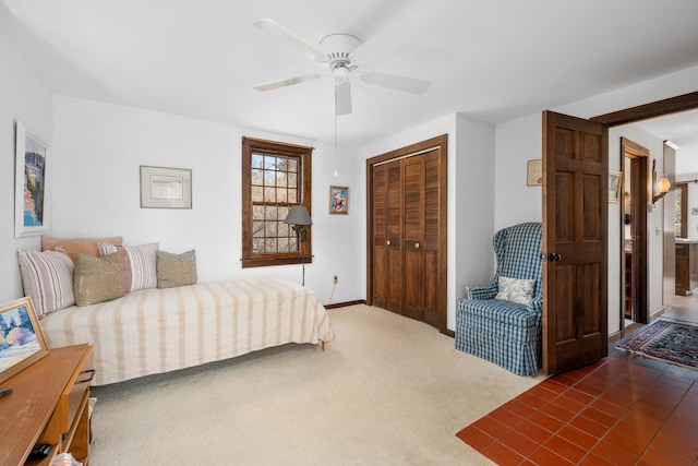 bedroom with a closet, carpet floors, and ceiling fan