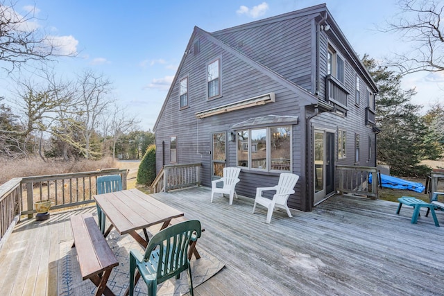 wooden terrace with outdoor dining area