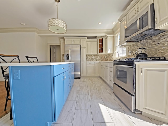 23 Old Barnstable Rd, East Falmouth, MA 02536 - kitchen with decorative backsplash, a kitchen island, a kitchen bar, appliances with stainless steel finishes, and ornamental molding