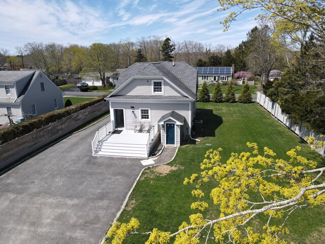 23 Old Barnstable Rd, East Falmouth, MA 02536 - view of front facade with aphalt driveway, fence, and a front yard
