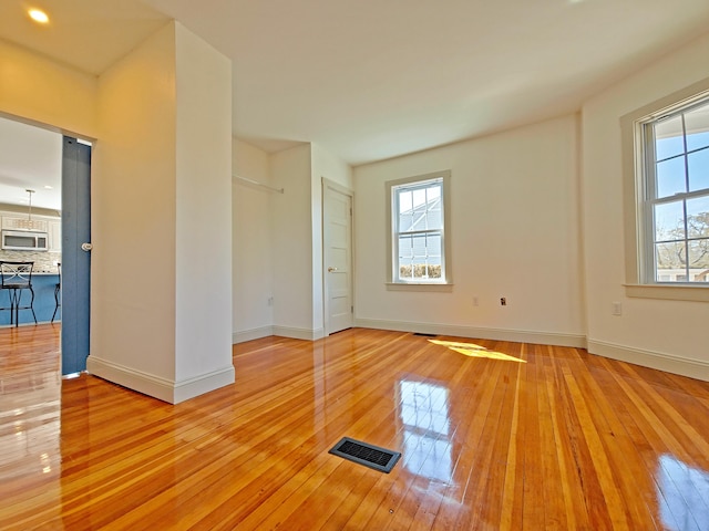 23 Old Barnstable Rd, East Falmouth, MA 02536 - empty room featuring baseboards, plenty of natural light, light wood-style flooring, and visible vents