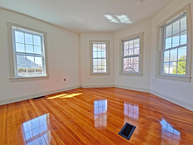 23 Old Barnstable Rd, East Falmouth, MA 02536 - empty room with baseboards, visible vents, and light wood-style flooring