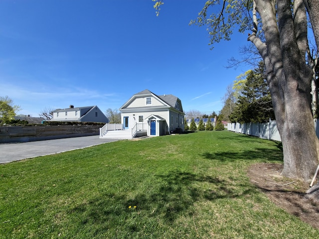 23 Old Barnstable Rd, East Falmouth, MA 02536 - view of front of property featuring fence, driveway, and a front yard
