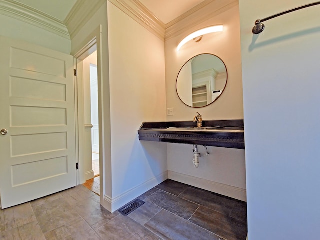 23 Old Barnstable Rd, East Falmouth, MA 02536 - bathroom with crown molding, a sink, baseboards, and visible vents
