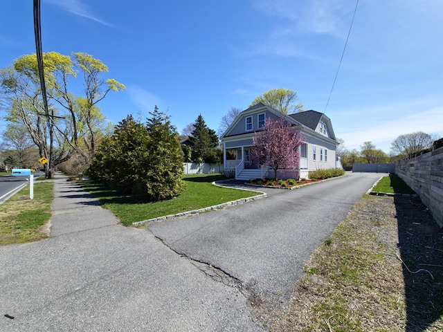 23 Old Barnstable Rd, East Falmouth, MA 02536 - view of front of house featuring fence and a front yard