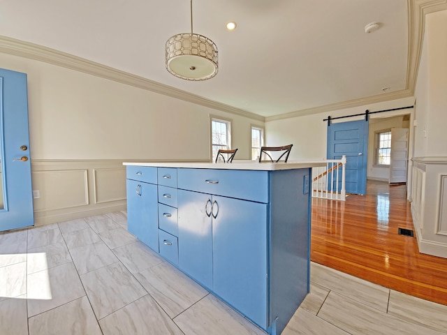 23 Old Barnstable Rd, East Falmouth, MA 02536 - kitchen featuring a kitchen island, blue cabinetry, visible vents, crown molding, and a barn door