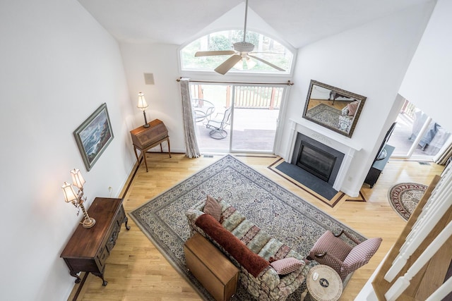 13 Laurel Hill Ct, Bourne, MA 02532 - living room with wood finished floors, vaulted ceiling, a ceiling fan, and a glass covered fireplace
