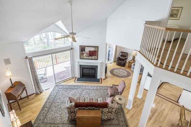 13 Laurel Hill Ct, Bourne, MA 02532 - living room with wood finished floors, high vaulted ceiling, a fireplace with flush hearth, and a ceiling fan