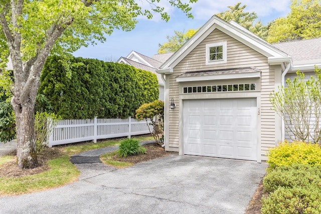 13 Laurel Hill Ct, Bourne, MA 02532 - garage with fence and asphalt driveway