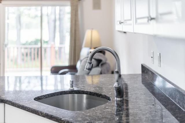 13 Laurel Hill Ct, Bourne, MA 02532 - kitchen view of dark stone counters, white cabinetry, and a sink