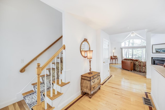 13 Laurel Hill Ct, Bourne, MA 02532 - corridor with light wood-style flooring, stairway, lofted ceiling, and baseboards