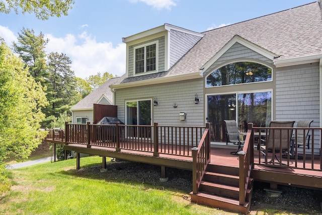 13 Laurel Hill Ct, Bourne, MA 02532 - back of property featuring roof with shingles, a deck, a lawn, and outdoor dining space