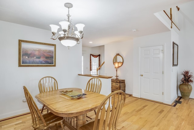 13 Laurel Hill Ct, Bourne, MA 02532 - dining room with a chandelier, light wood-style floors, and baseboards