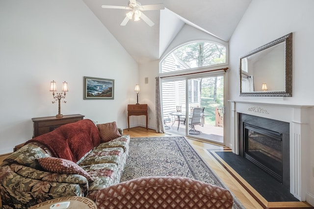 13 Laurel Hill Ct, Bourne, MA 02532 - living room with ceiling fan, a fireplace with flush hearth, wood finished floors, and high vaulted ceiling