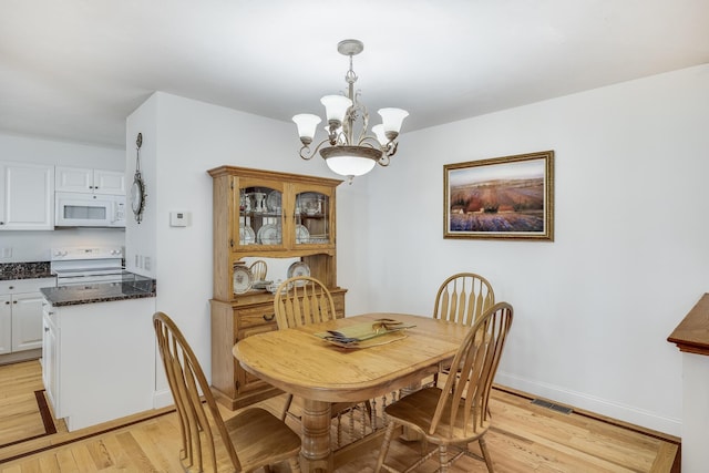 13 Laurel Hill Ct, Bourne, MA 02532 - dining room with a chandelier, light wood-style flooring, and baseboards